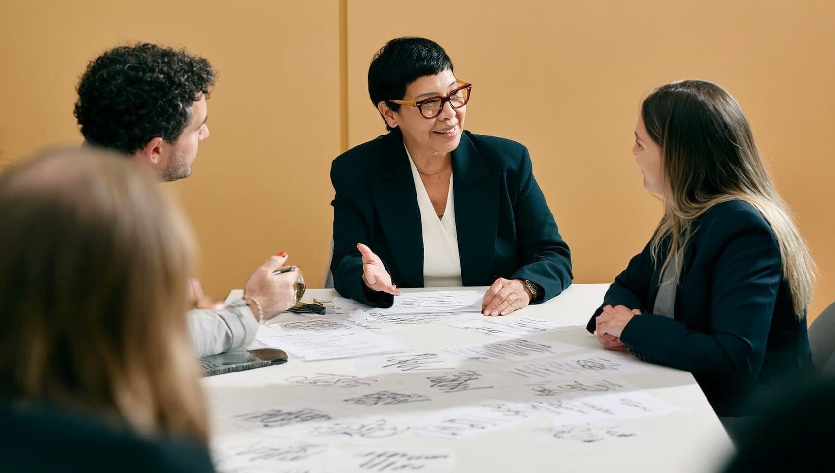 Publicist briefing a client before a media appearance, notes and talking points on the table